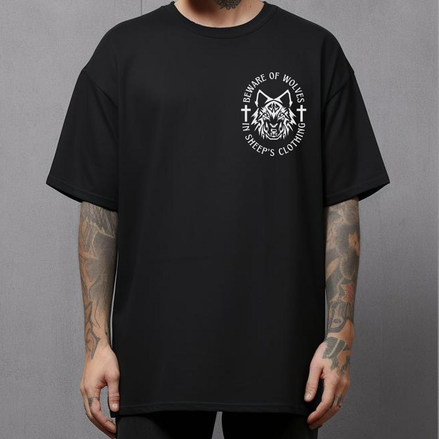 tattooed man wearing a crewneck short sleeve black christian streetwear graphic tee that says beware of wolves on the front