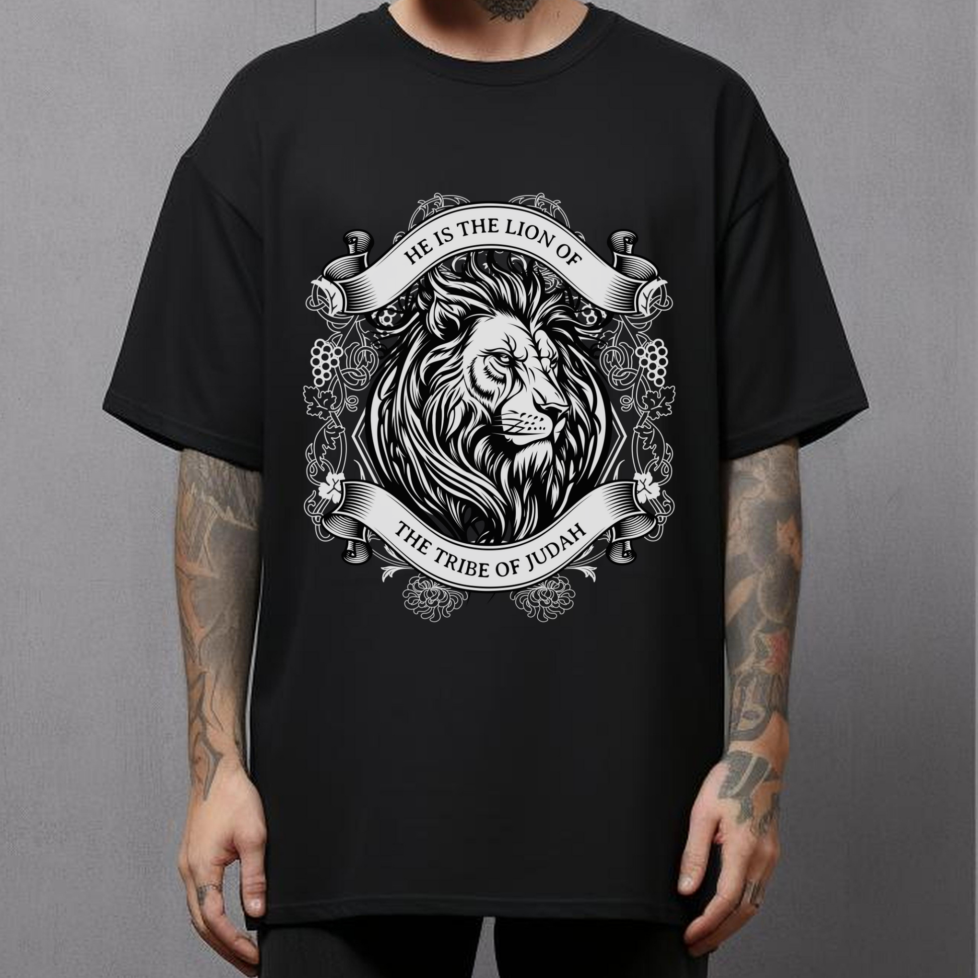 man wearing a christian streetwear shirt that is black with short sleeves that has a lion and says He is the lion of the Tribe of Judah