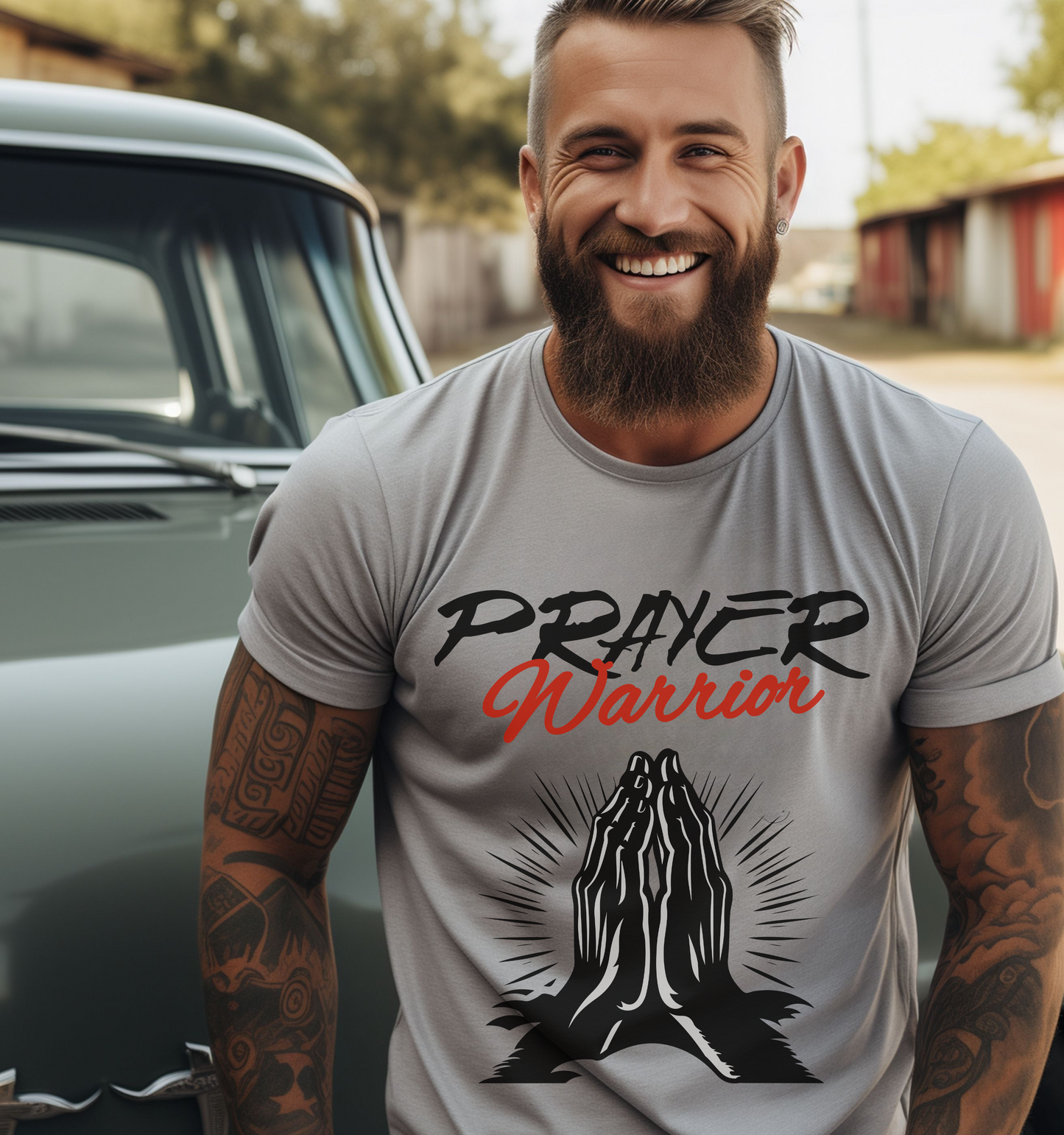 man wearing christianity clothing in a silver crew neck short sleeve graphic tshirt that says prayer warrior with an image of praying hands