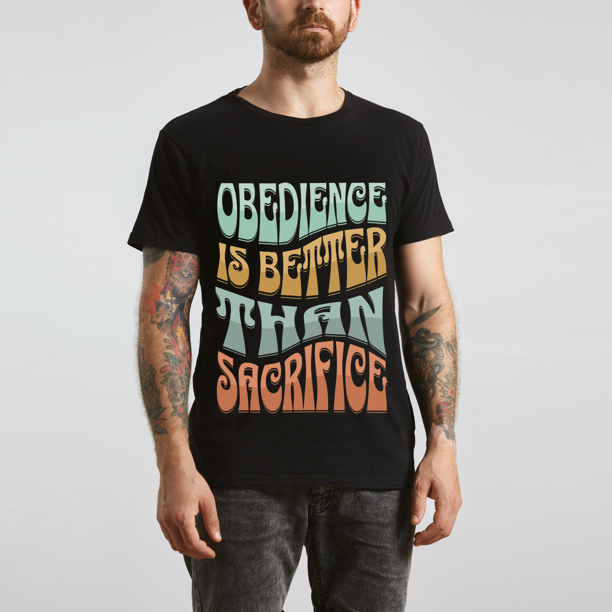 man wearing christian apparel in a black crew neck short sleeve graphic tee that says obedience is better than sacrifice