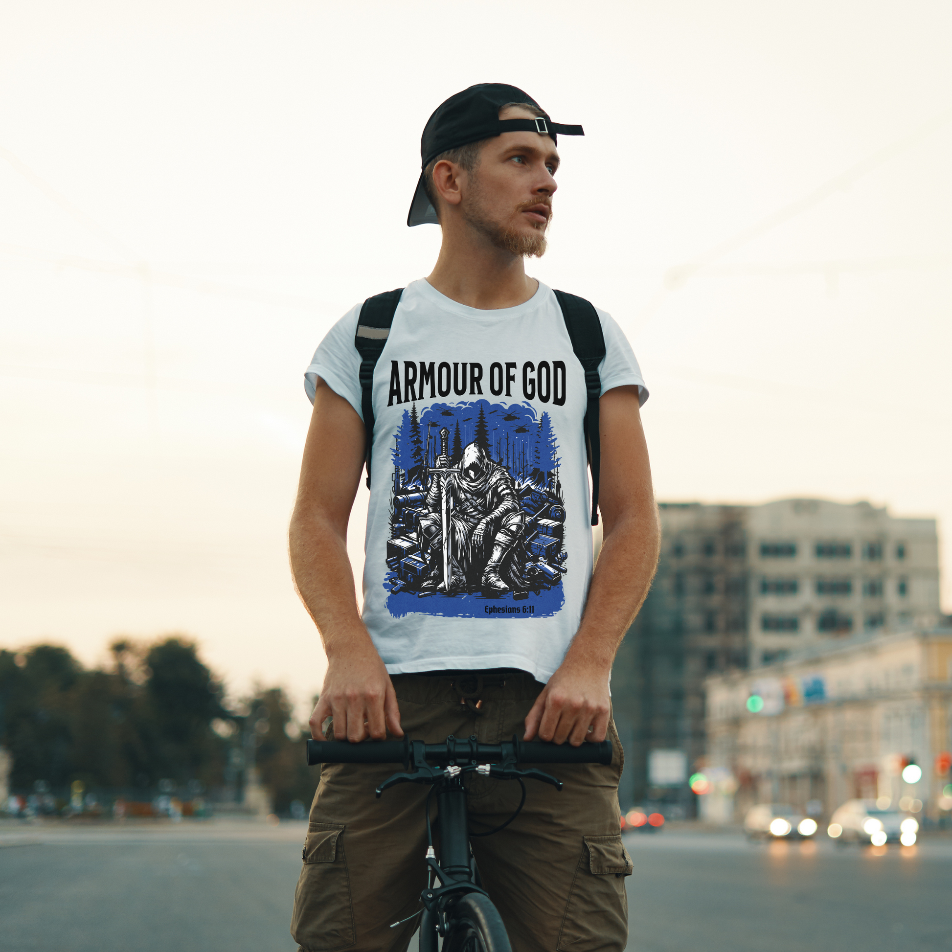 man riding a bike wearing a white short sleeve crew neck christian tshirt mens that says armour of god